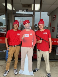 two window cleaners posing wtih carboard-cut-out of jake from state farm