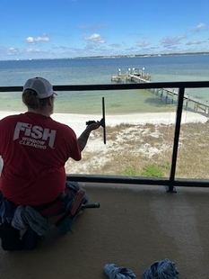 window cleaner cleaning glass balcony of a house