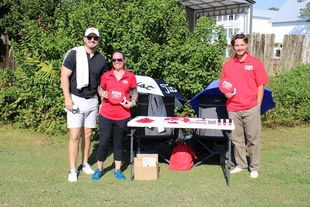 owner danica lafaire with man and fish employee at a fish window cleaning booth