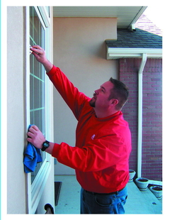 owner bob johnson cleaning windows of a house