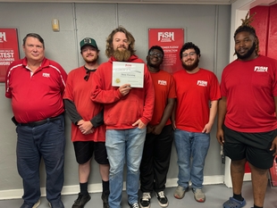 group picture of fish team with an award