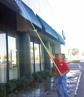 window cleaner cleaning overhangs of a building