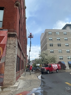 window cleaners cleaning windows of tall building