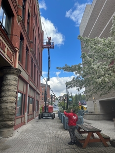 window cleaners cleaning windows of tall building