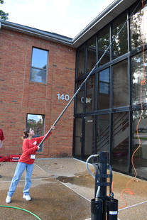 window cleaner cleaning windows of building