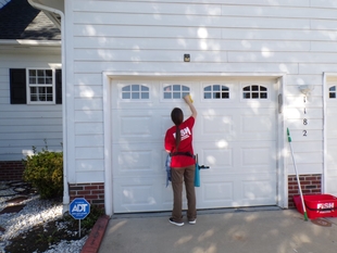 window cleaner cleaning windows of a garage