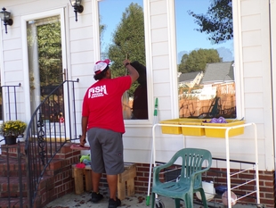 window cleaner cleaning window of a house