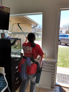 window cleaner cleaning the interior window of a building