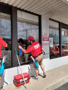 window cleaner cleaning windows of a building