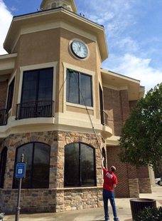 Cleaning Windows With A Water-Fed Pole