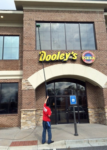 Cleaning Dooley's Windows With A Water-Fed Pole