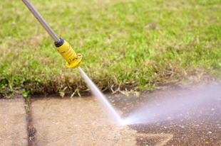 Stock Image of Pressure Washer Cleaning Concrete Sidewalk