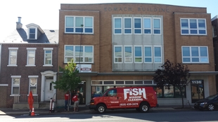 red fish window cleaning van parked in front of a building