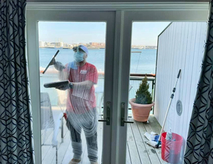 Image of Fish Window Cleaner Cleaning Windows Overlooking Harbor