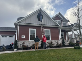 Fish Window Cleaning installing Christmas lights on a residential home