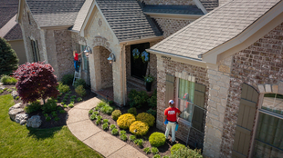 Aerial Image of Home and Two Fish Window Cleaners Cleaning Windows