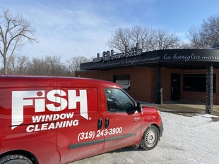 red fish window cleaning van parked in front of building