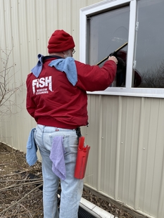 window cleaner cleaning window of a building