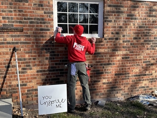 window cleaner cleaning window of a house