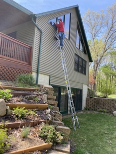 Image of FISH Window Cleaner Cleaning 2nd Story Home Windows on a Ladder