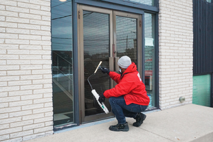 FISH Window Cleaner Kneeling to Clean Glass Entry Doors