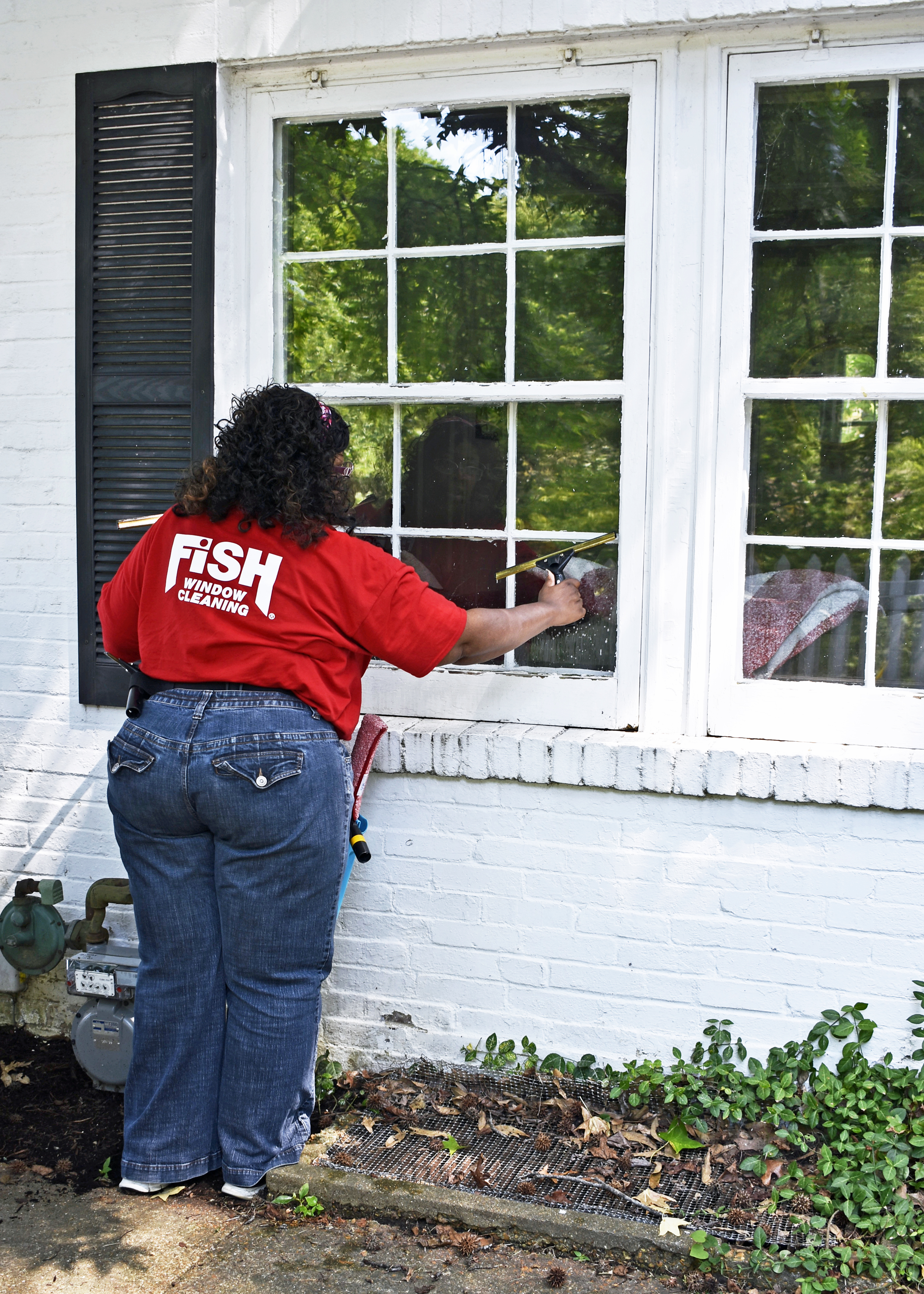 Image of Franchise Owner Sharon Alexander Cleaning Home Window