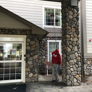 Image of Window Cleaner Cleaning 2nd Story Home Windows