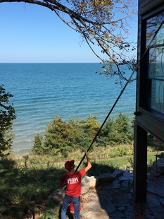 window cleaner cleaning windows of a house