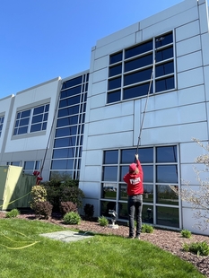 window cleaner cleaning windows of a building