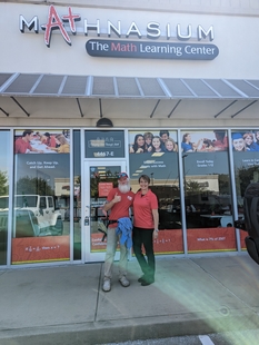 window cleaner posing with owner/employee of mathnasium