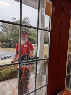 Fish Window Cleaner Using Water-Fed Pole to Clean Exterior of Children in Crisis Window