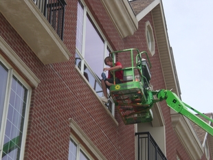 window cleaner cleaning window of a building from high up