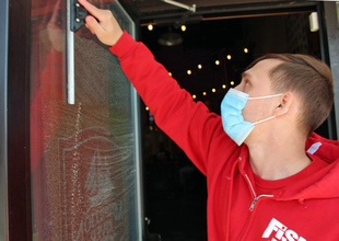 Fish Window Cleaner Cleaning Window While Wearing A Face Mask