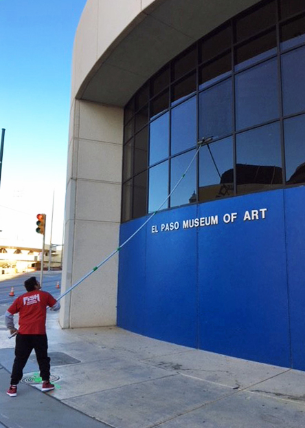 Image of Fish Window Cleaner Cleaning Museum Building Windows with a Pole