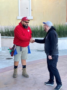 Klatch Coffee Employee Shaking Hands with Fish Window Cleaner