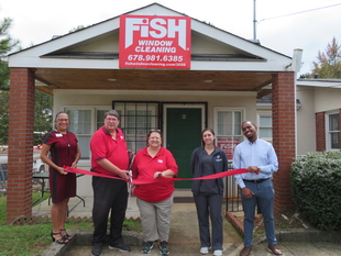 Franchise Owners with Local Chamber of Commerce Members at Ribbon Cutting Outside FISH Office