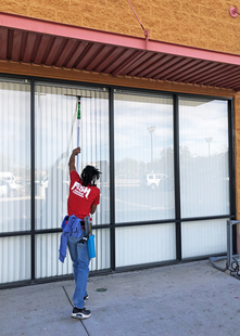 FISH Window Cleaner Cleaning Storefront Windows with a Pole