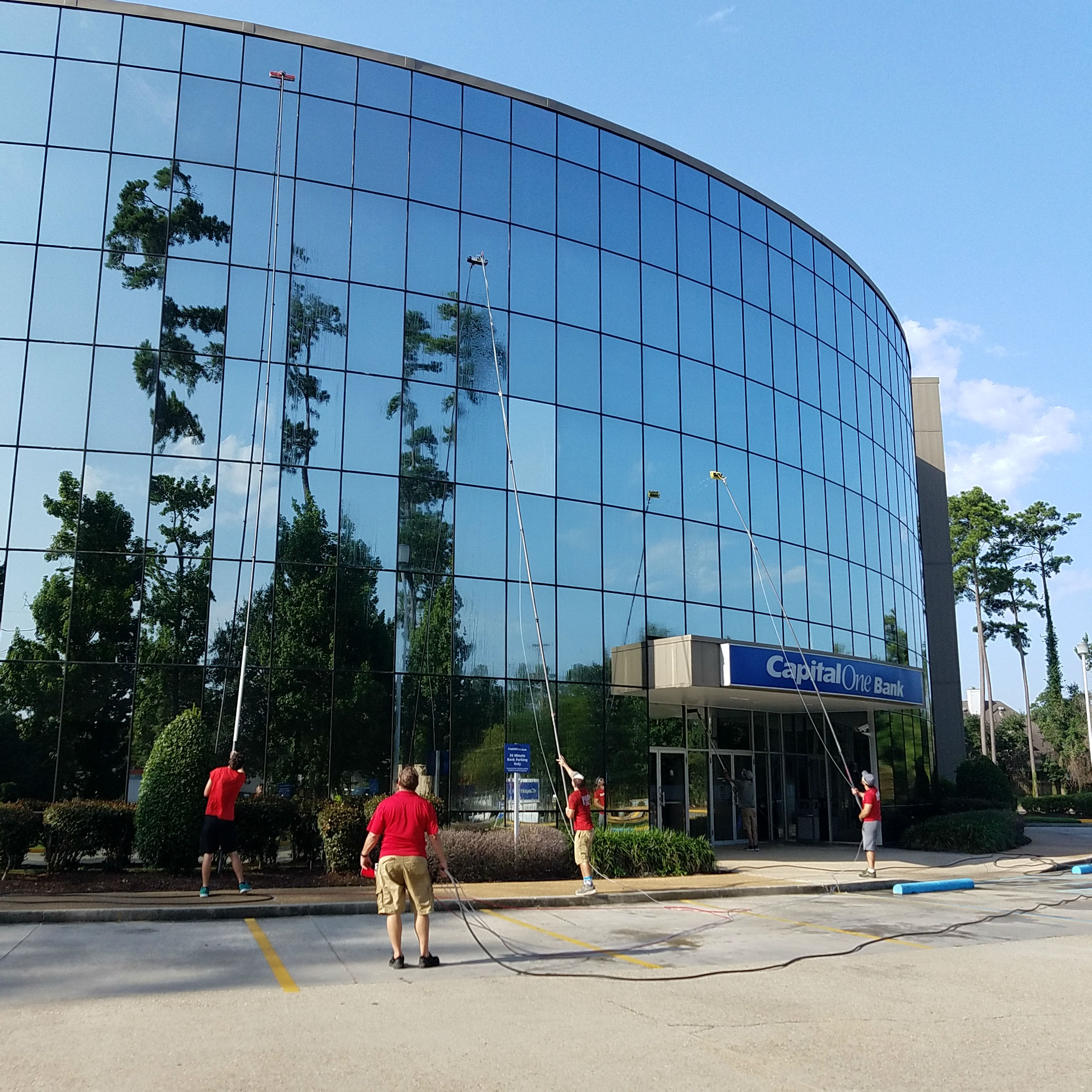 Cleaning Exterior Windows of Multi-Story Building with Poles