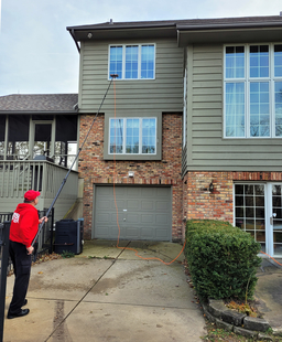 Window Cleaner Using Water-Fed Pole to Clean 2nd Story Windows Above Garage