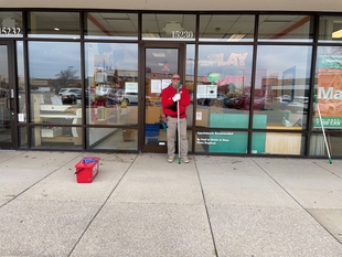 window cleaner cleaning windows of a store
