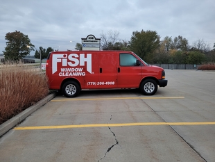 red fish window cleaning van parked in a parking lot