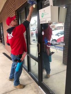 FISH Window Cleaner Cleaning Cobwebs from Around Children's Advocacy Center Windows