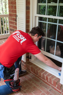 Image of Window Cleaner Wiping Sills of Residential Window