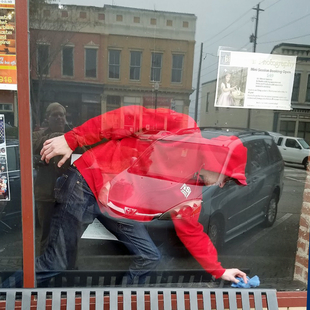 FISH Window Cleaner Wiping Sill of Storefront Window