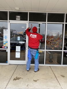 FISH Window Cleaner Cleans Storefront Window with a Mop