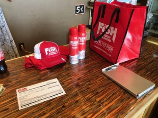 Fish Window Cleaning Hats, Glass Cleaner, and Tote Bags on Table