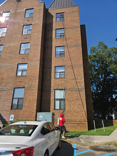cleaning windows of tall building