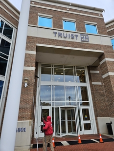 window cleaner cleaning windows of truist bank