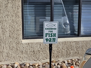 parking spot reserved for fish window cleaning van