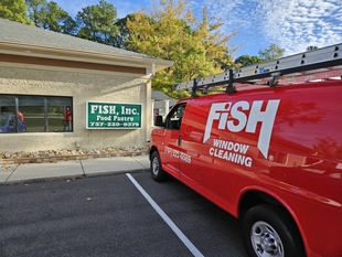 fish window cleaning van parked in front of building